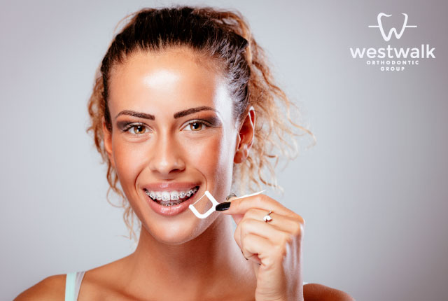Leaning to floss and brush your teeth during orthodontics is essential.